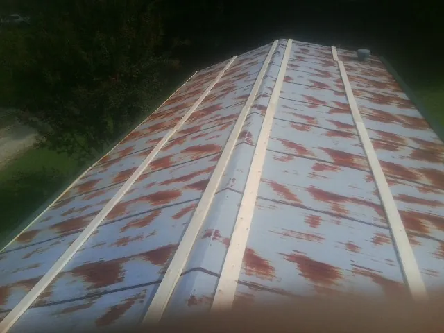 Rusted metal roof panels with new wood purlins before replacement — Storm Damage Roof Repair in Myerstown by Roofing Brothers