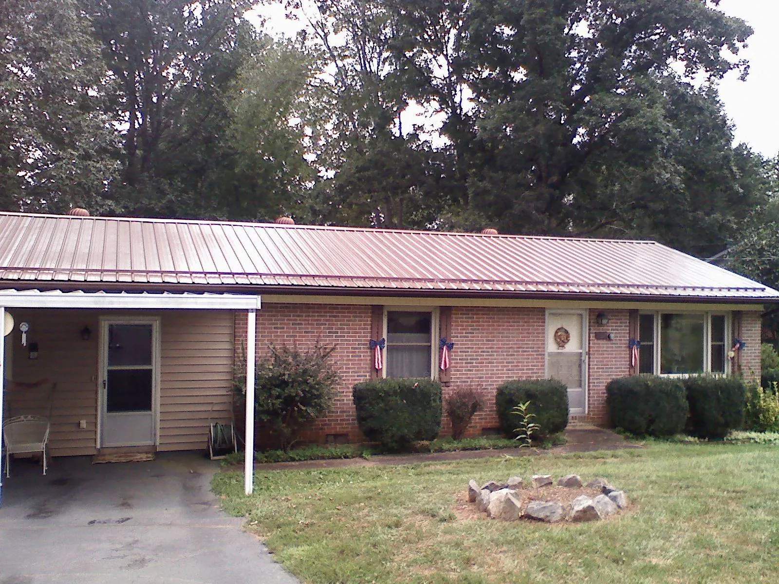 Bronze metal roof and carport on a brick ranch home — Roof Repair work by our crew in Myerstown