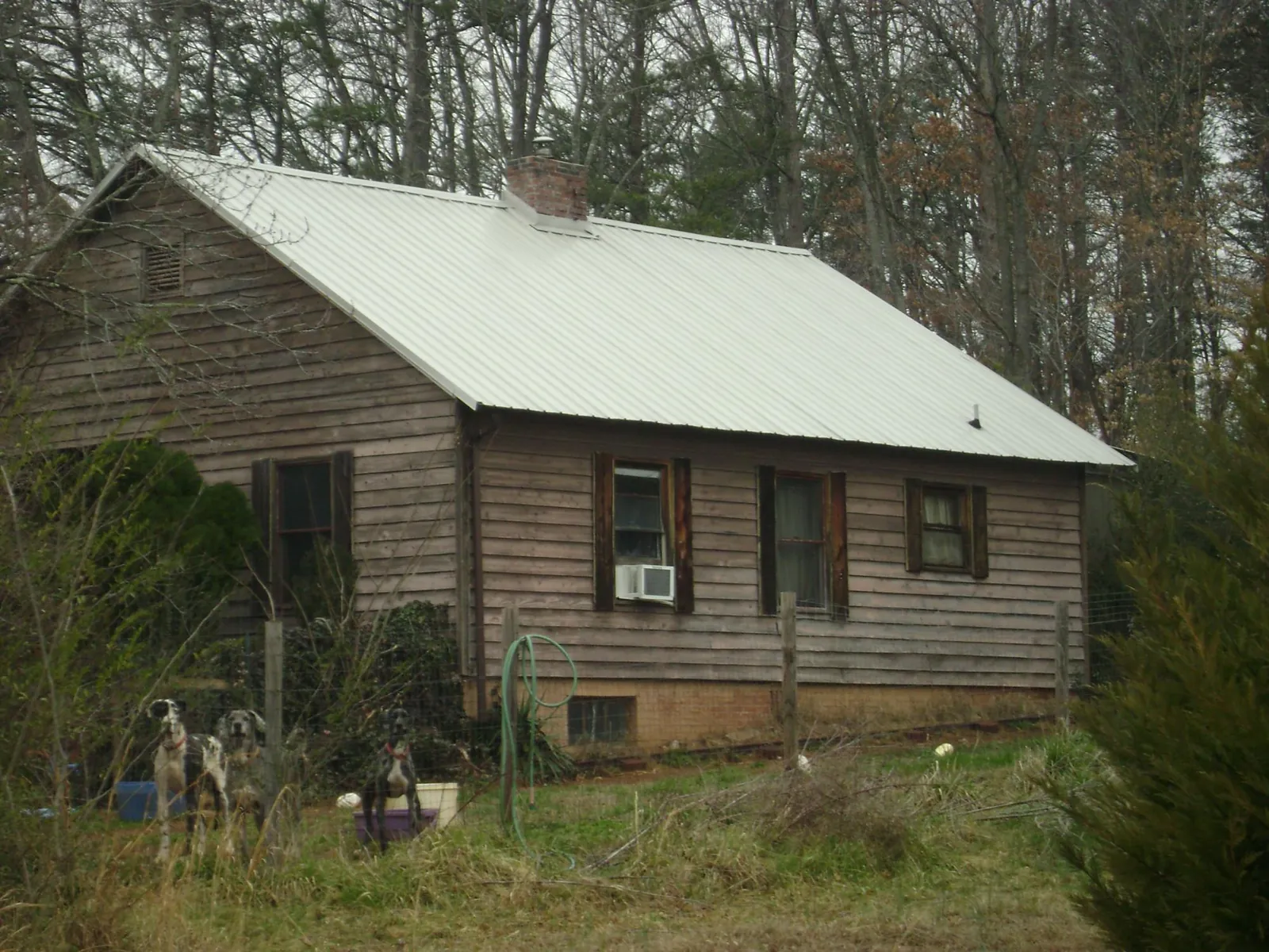 White metal roof on an old wood sided farmhouse, from a Asphalt Shingle Roof Repair job in Myerstown